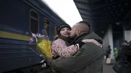 Ukrainian soldier Vasyl Khomko hugs his daughter