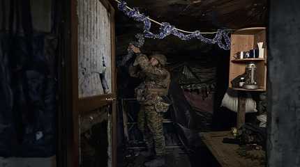 Ukrainian soldier decorates a frontline position