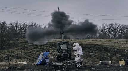 soldiers fire a self-propelled howitzer