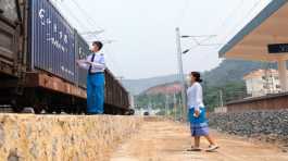 Two staff members of the China-Laos Railway inspect