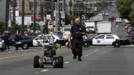 police officer uses a robot to investigate a bomb threat
