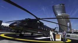 Russian salespeople stand by a helicopter