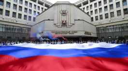 People hold a Russian flag